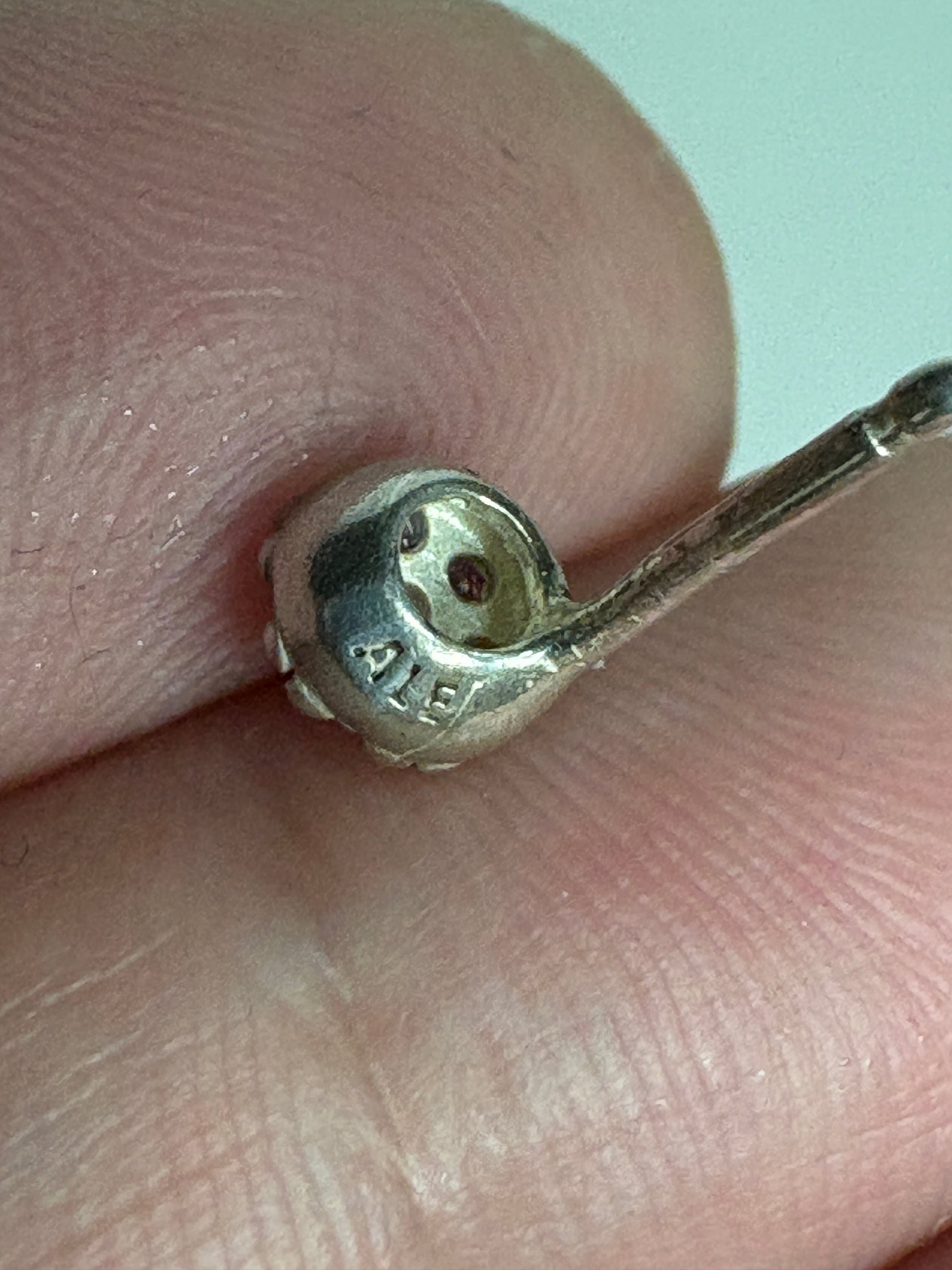 Sterling silver stud earrings with violet purple pave stones.