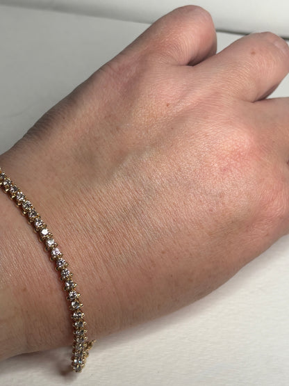 A 7-inch 14k gold tennis bracelet with 57 diamonds.