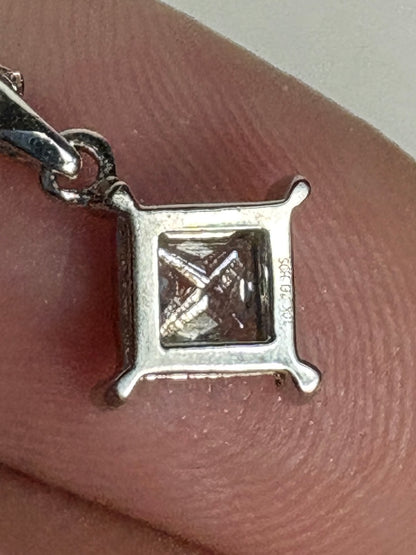 10k white gold pendant with a princess cut diamond.