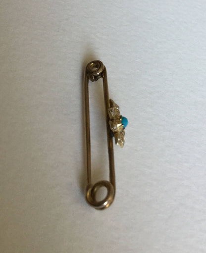Gold pin with a turquoise and seed pearl daisy brooch.