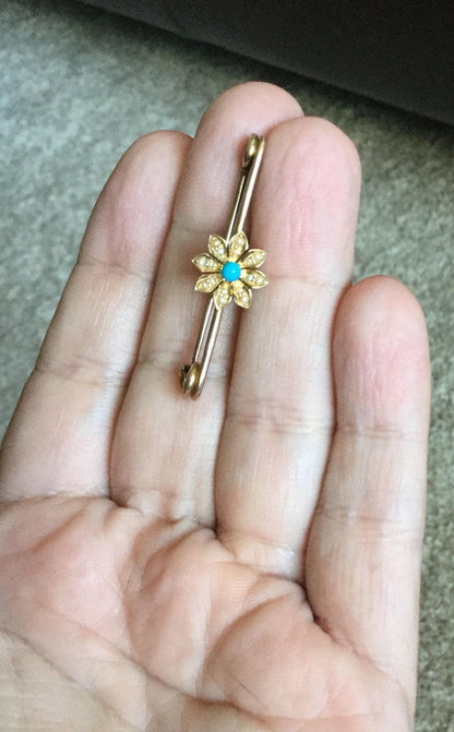 Gold brooch with turquoise and seed pearls in a daisy design.