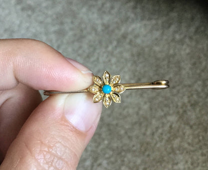 Gold flower brooch with turquoise and seed pearls.