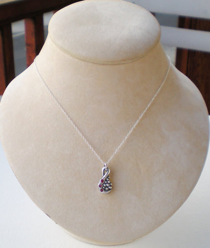 Fine solid silver pendant with natural rubies on a silver chain.
