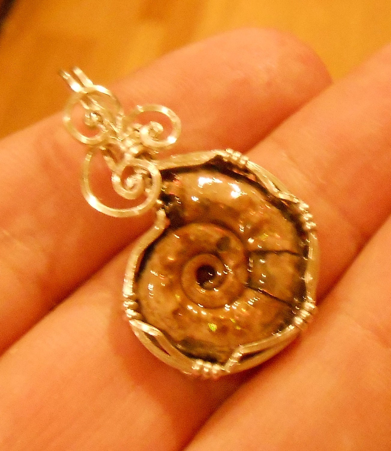 Pyritized Ammonite fossil pendant with ammolite features sterling silver wire wrapped