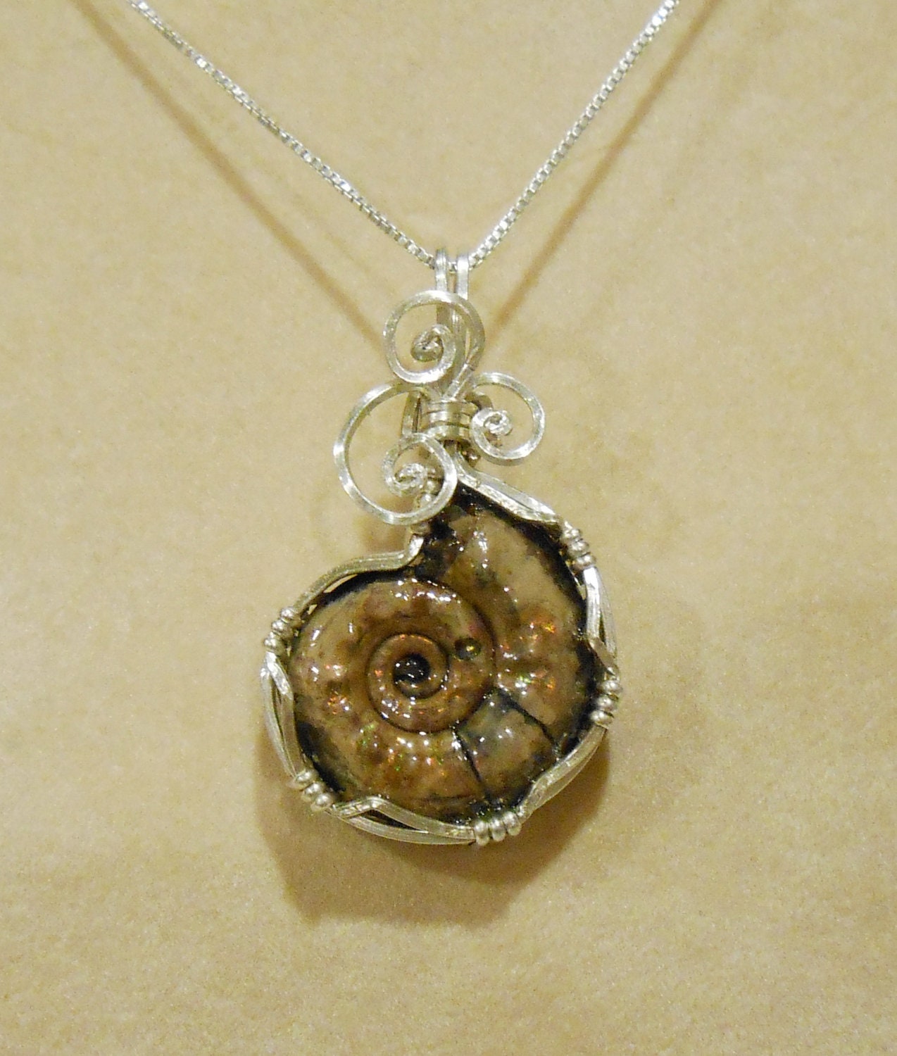 Pyritized Ammonite fossil pendant with ammolite features sterling silver wire wrapped