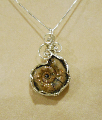 Pyritized Ammonite fossil pendant with ammolite features sterling silver wire wrapped