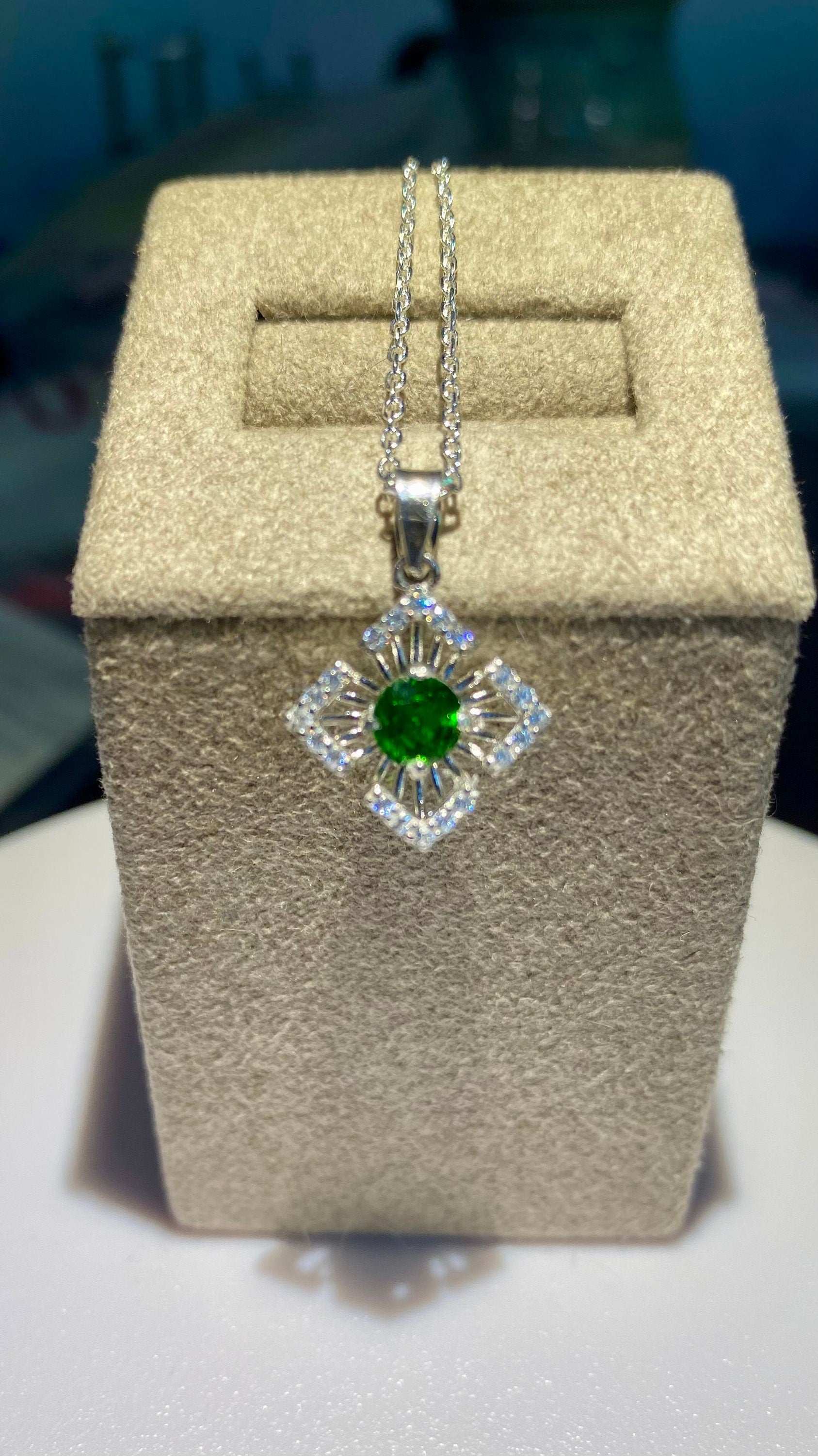 Sterling silver pendant necklace with a green chrome diopside center and cubic zirconia accents.