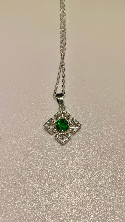 Sterling silver pendant necklace with a green chrome diopside center and clear accents.