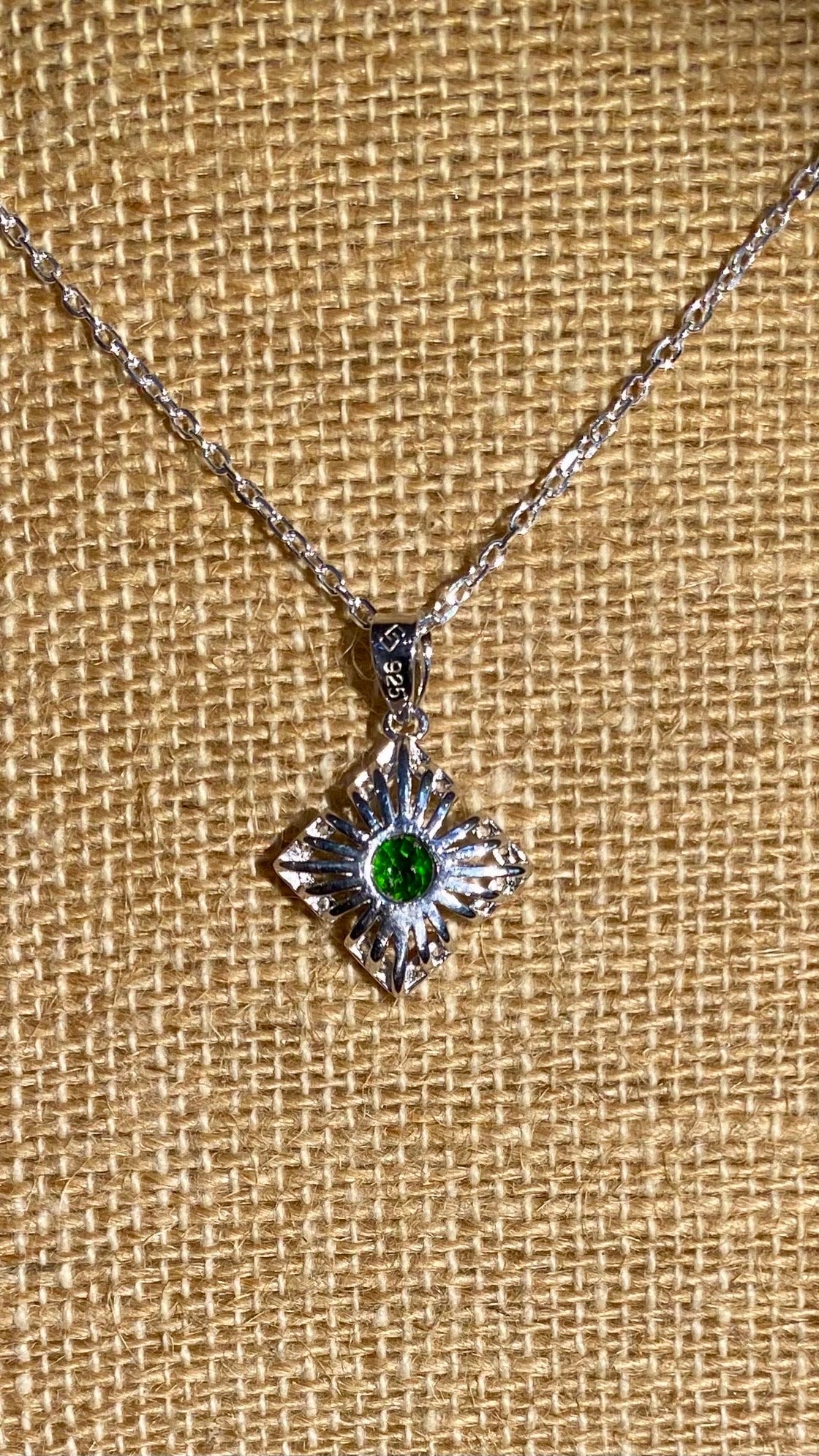 Sterling silver necklace with a square sunbeam pendant featuring a green chrome diopside gem.