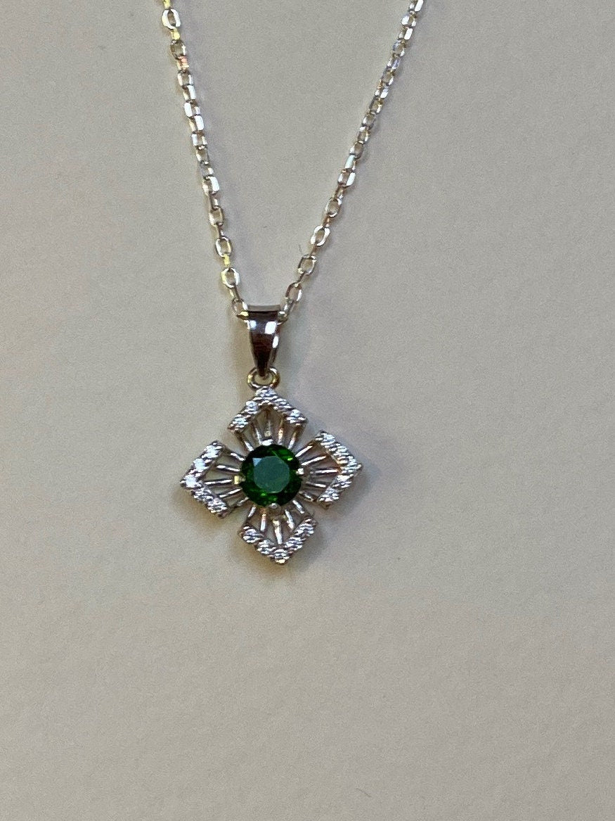 Sterling silver pendant necklace with a green chrome diopside center and cubic zirconia accents.