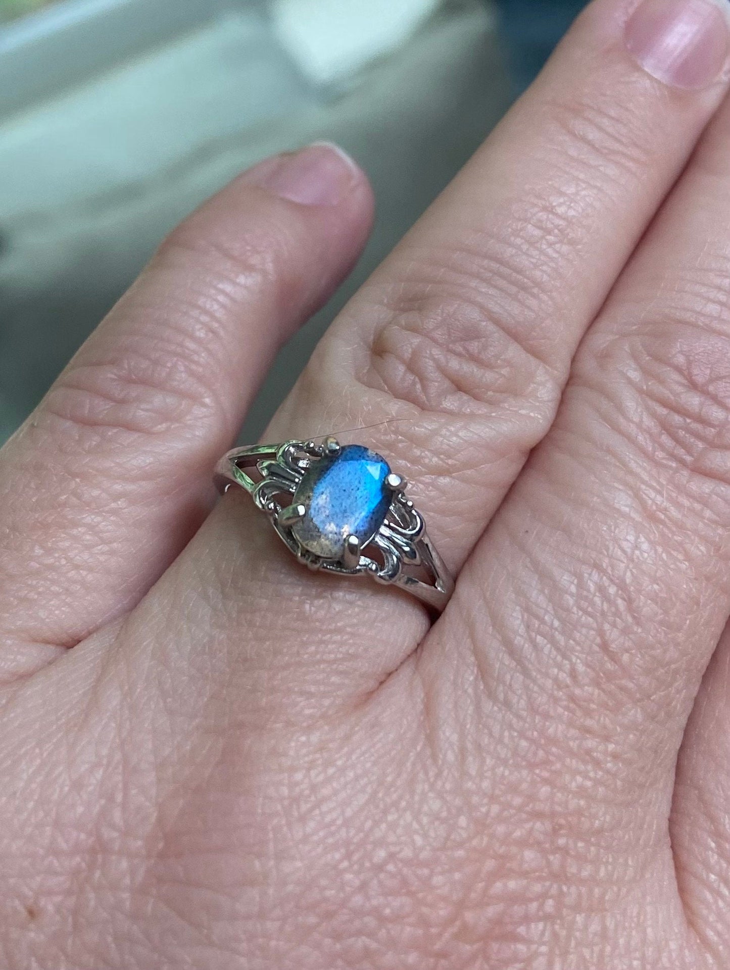 Sterling silver ring with a blue flash labradorite stone and fleur de lis design.