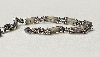 Multi-color sapphire fine PMC silver and sterling hand-forged station bracelet.