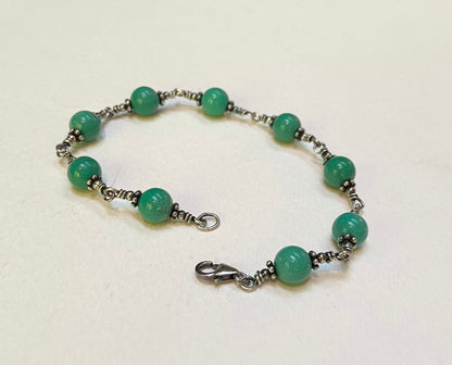 Sterling silver bracelet with blue jasper beads and a lobster clasp.