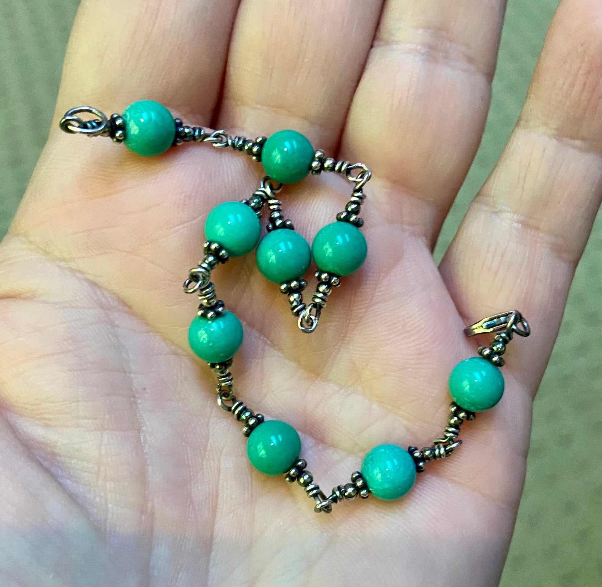 Sterling silver bracelet with blue jasper beads and wire wrapping.