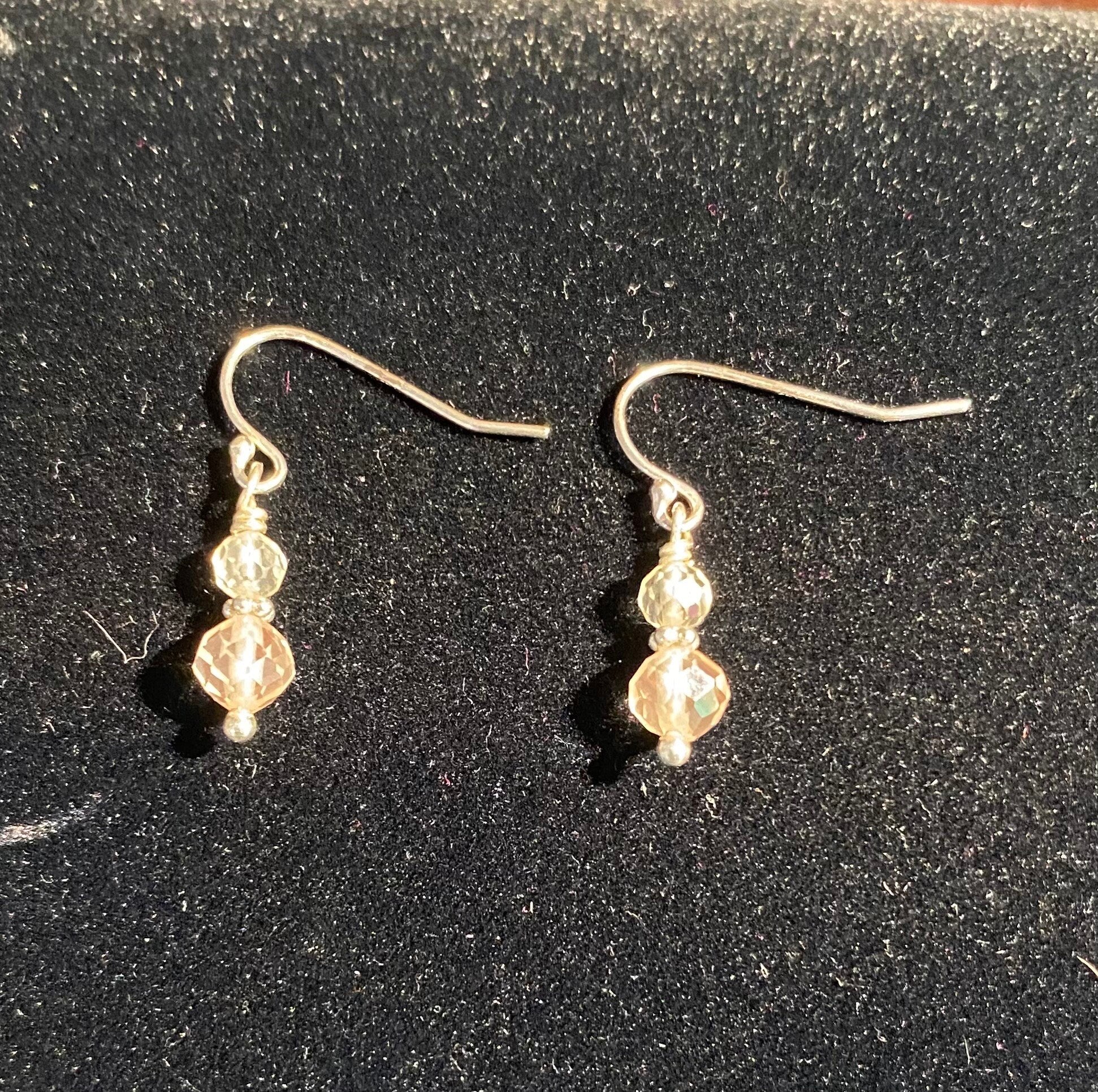 Sterling silver dangle earrings with two Oregon Sunstone beads.