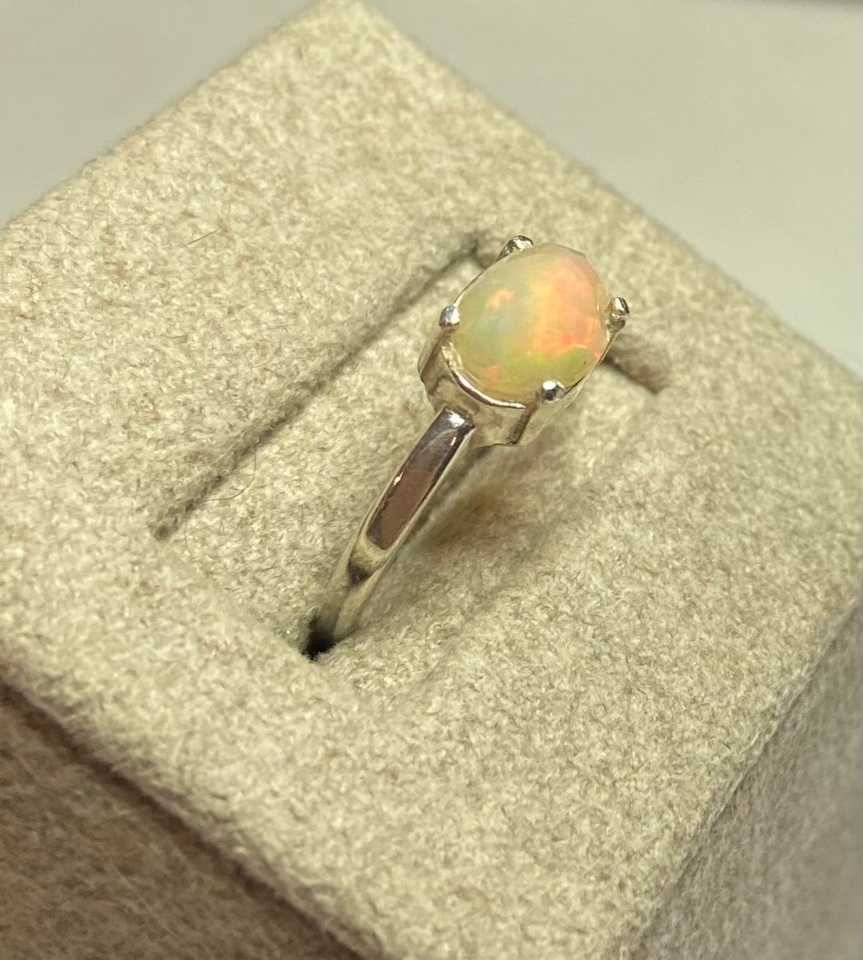 Oval faceted Ethiopian Wello opal ring in sterling silver.