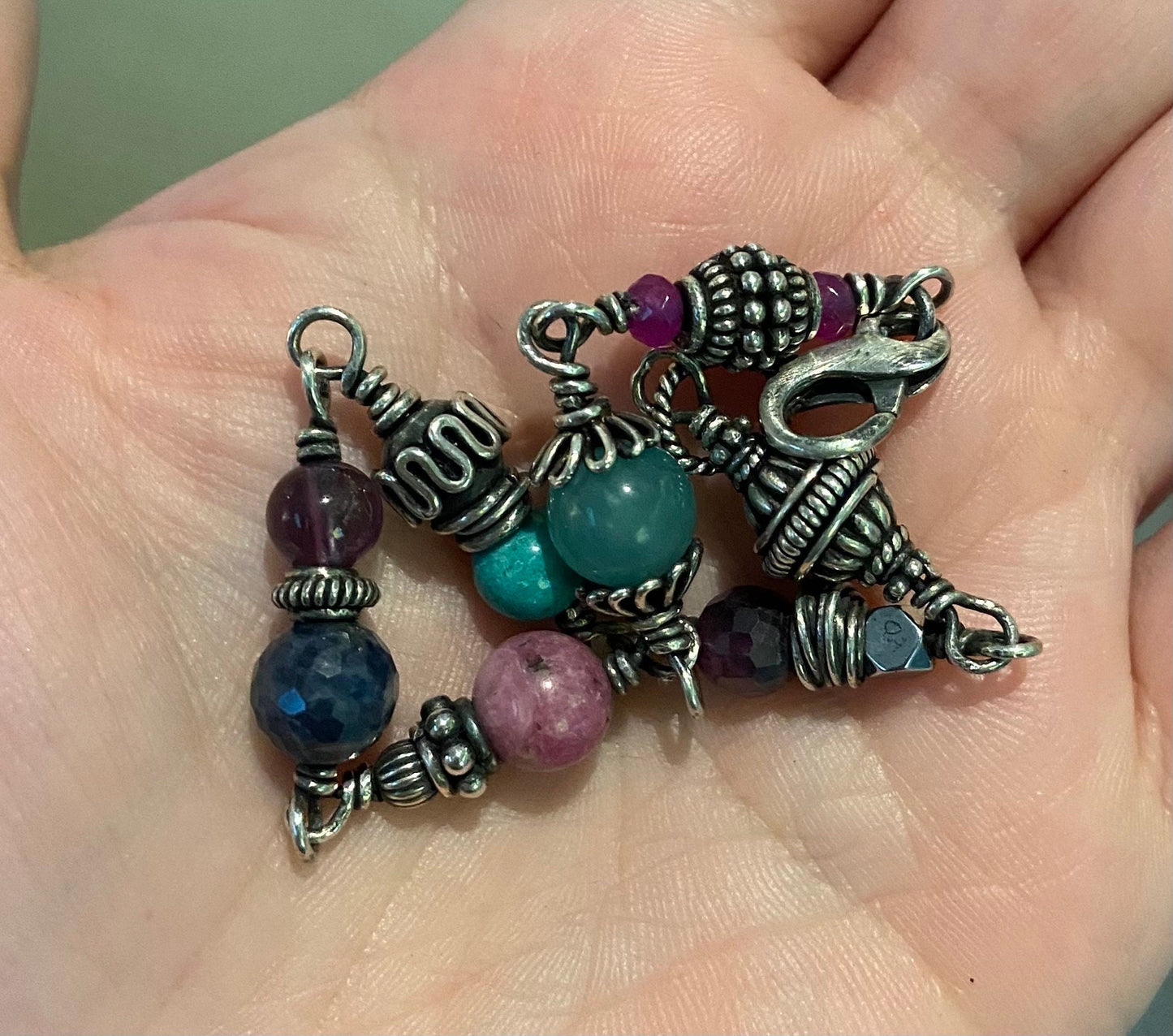 Sterling silver beaded bracelet with multiple colorful gemstones.