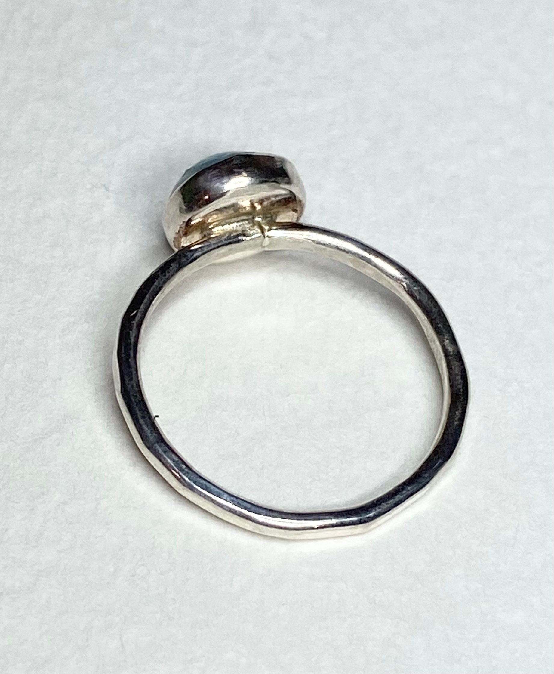 Sterling silver band ring with a bezel-set larimar cabochon.