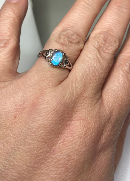 Sterling silver ring with a blue flash labradorite stone in a fleur de lis setting.