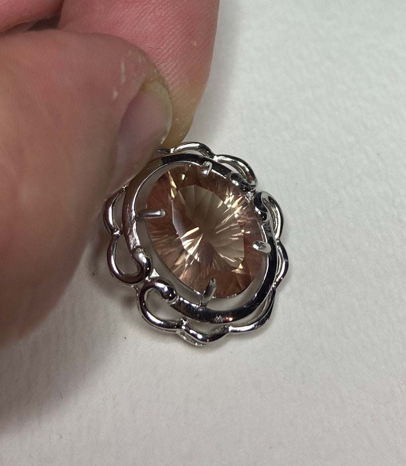 Sterling silver pendant featuring a large oval fancy cut Oregon sunstone.