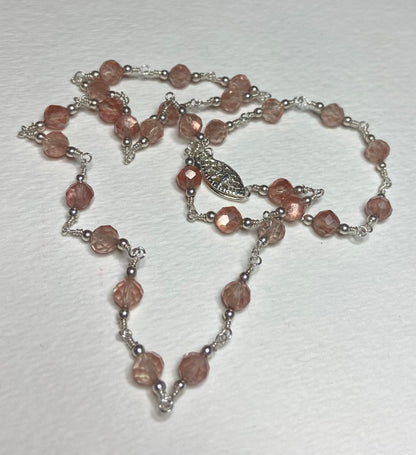 Sterling silver necklace with faceted Oregon sunstone beads and a filigree clasp.