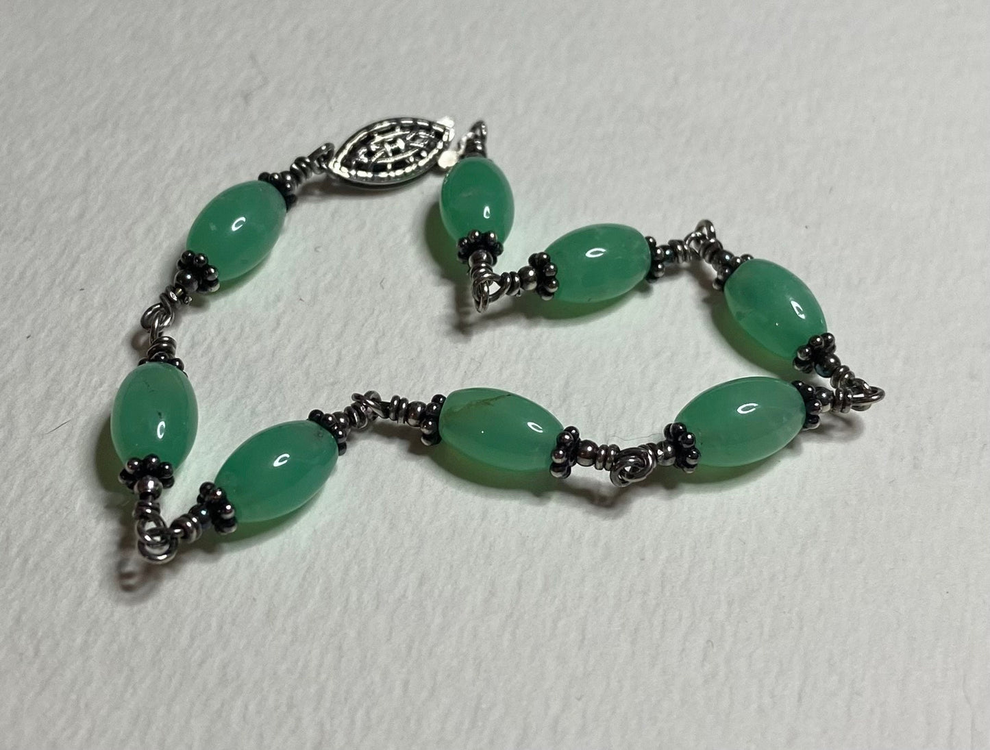 Chrysoprase sterling silver wire bracelet with filigree clasp.