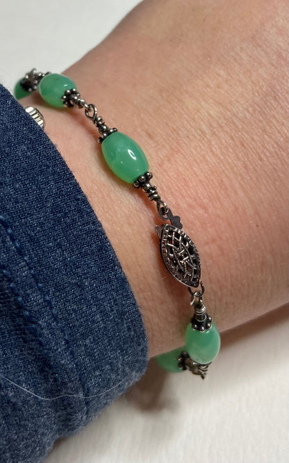 Sterling silver bracelet with oval chrysoprase beads and filigree clasp.