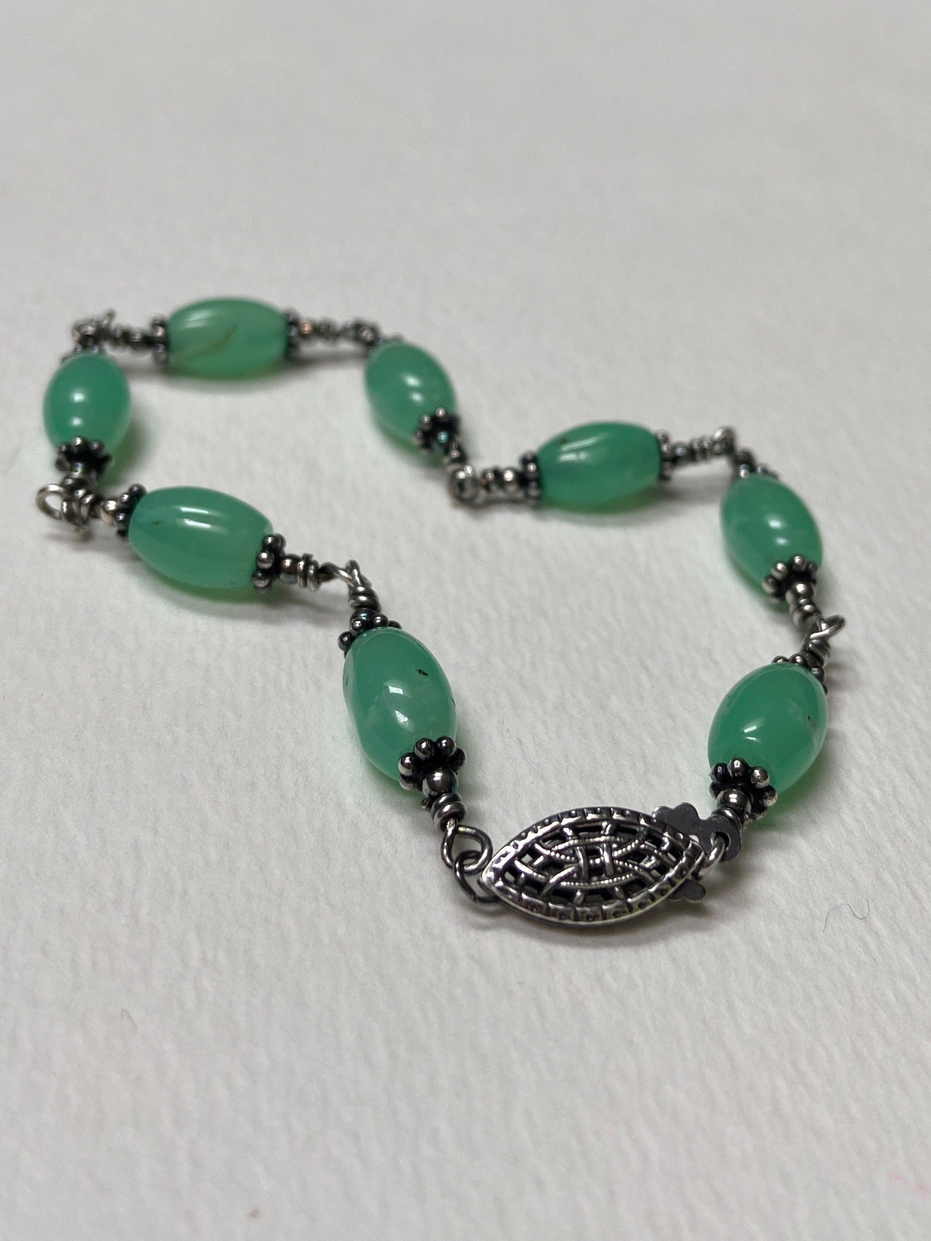 Sterling silver bracelet with barrel-shaped chrysoprase beads and filigree clasp.