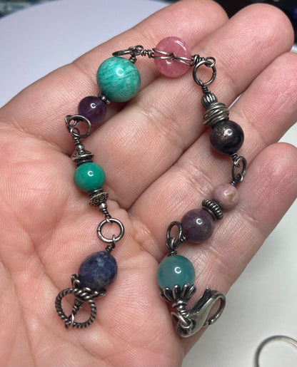 Sterling silver beaded bracelet with star sapphire, amazonite, rhodochrosite, and other gems.
