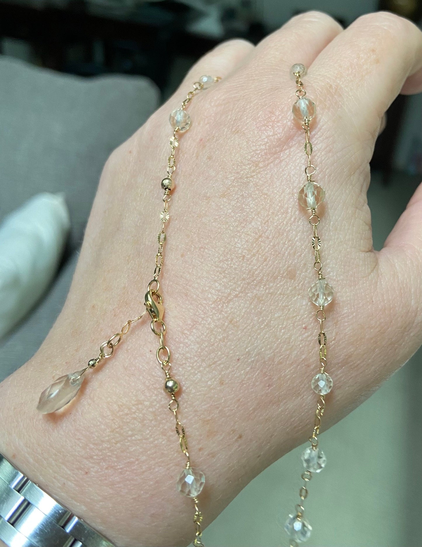 A delicate 14k yellow gold choker necklace with light yellow Oregon Sunstone beads and a briolette charm.