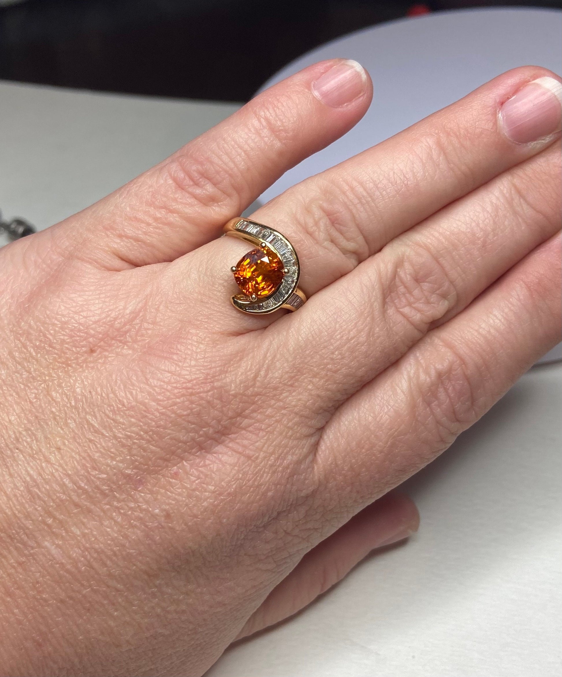 18k yellow gold ring with spessartite garnet and baguette diamonds.