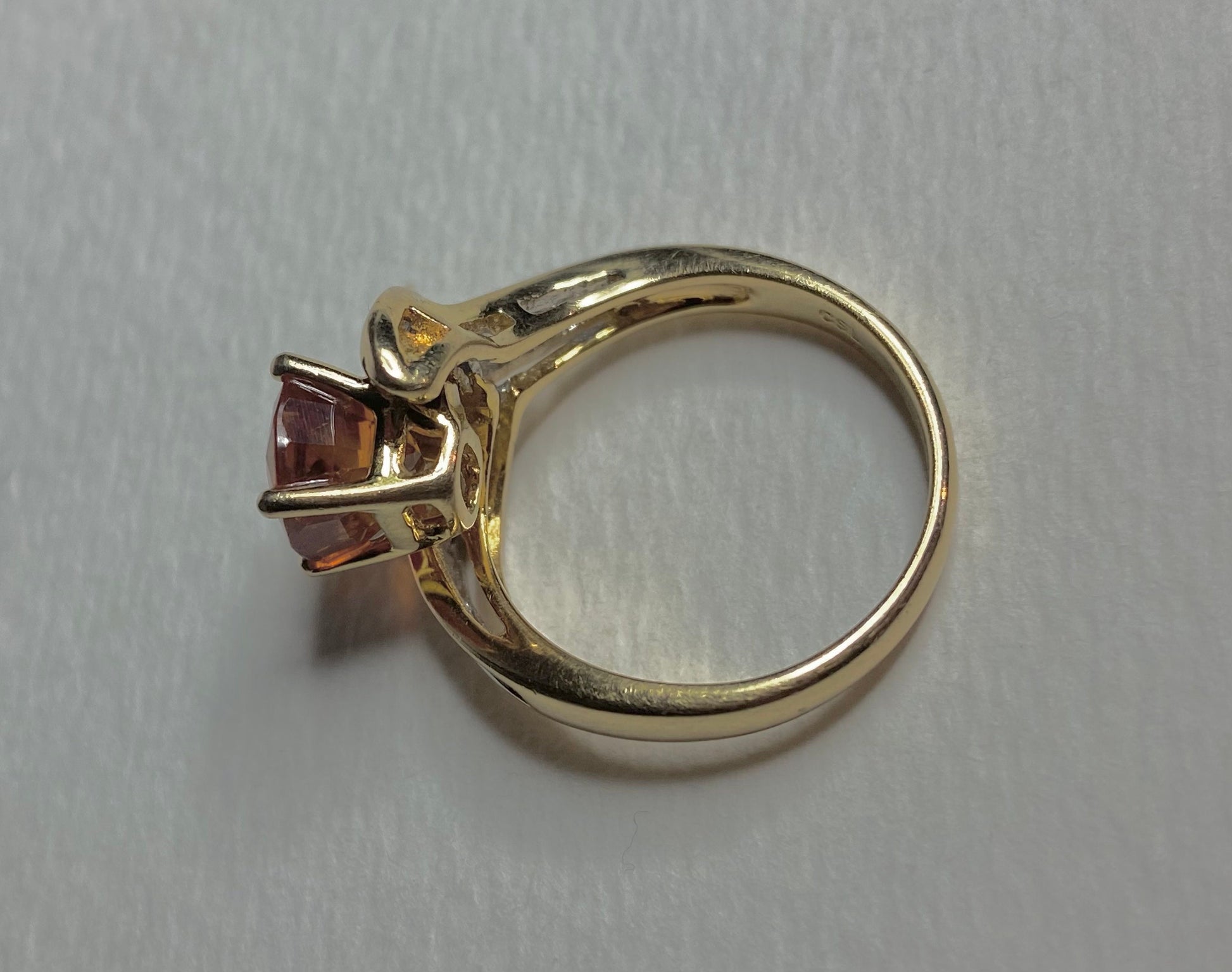 18k yellow gold ring with a spessartite garnet and baguette diamonds.