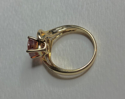 18k yellow gold ring with a spessartite garnet and baguette diamonds.