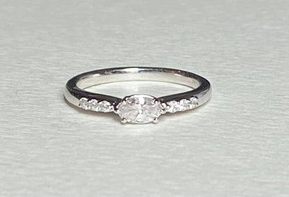 A 14k white gold band ring with a marquise-cut pink diamond and six white accent diamonds.