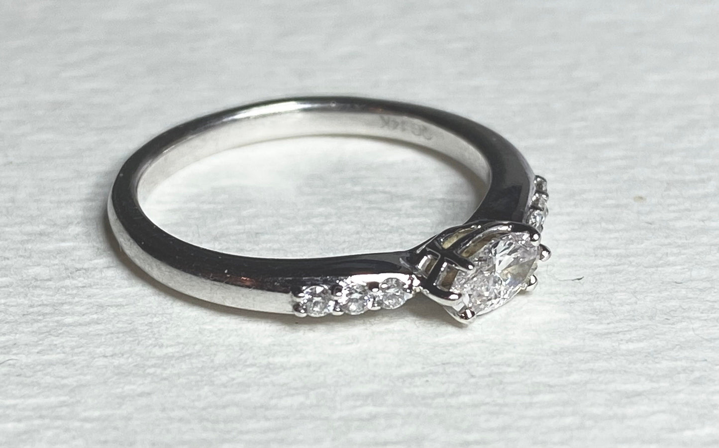 A 14k white gold band ring with a marquise-cut pink diamond and accent diamonds.
