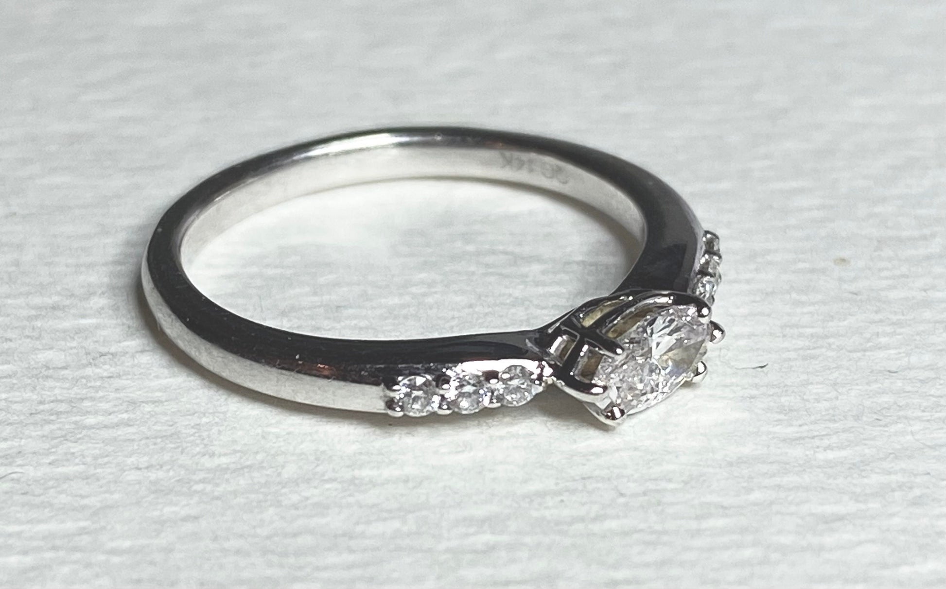 A 14k white gold band ring with a marquise-cut pink diamond and accent diamonds.