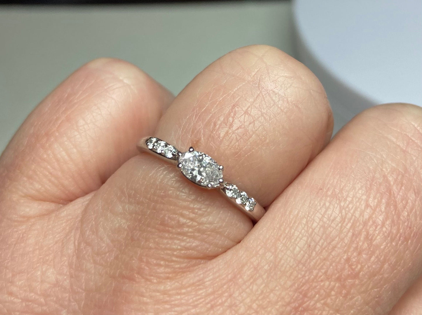 A 14k white gold band ring with a marquise-cut pink diamond and accent diamonds.