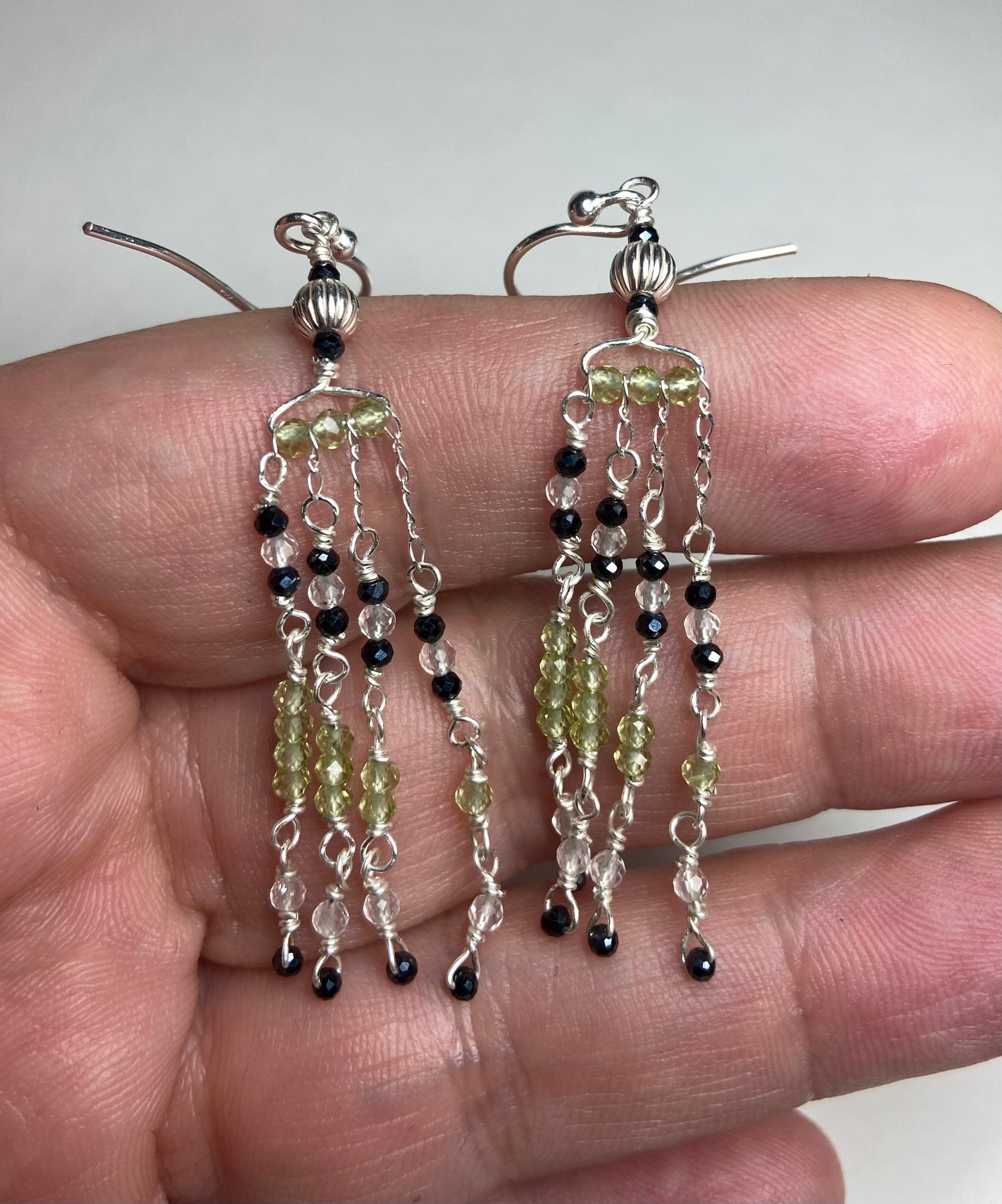 Sterling silver dangle earrings with black diamond and peridot beaded fringe.