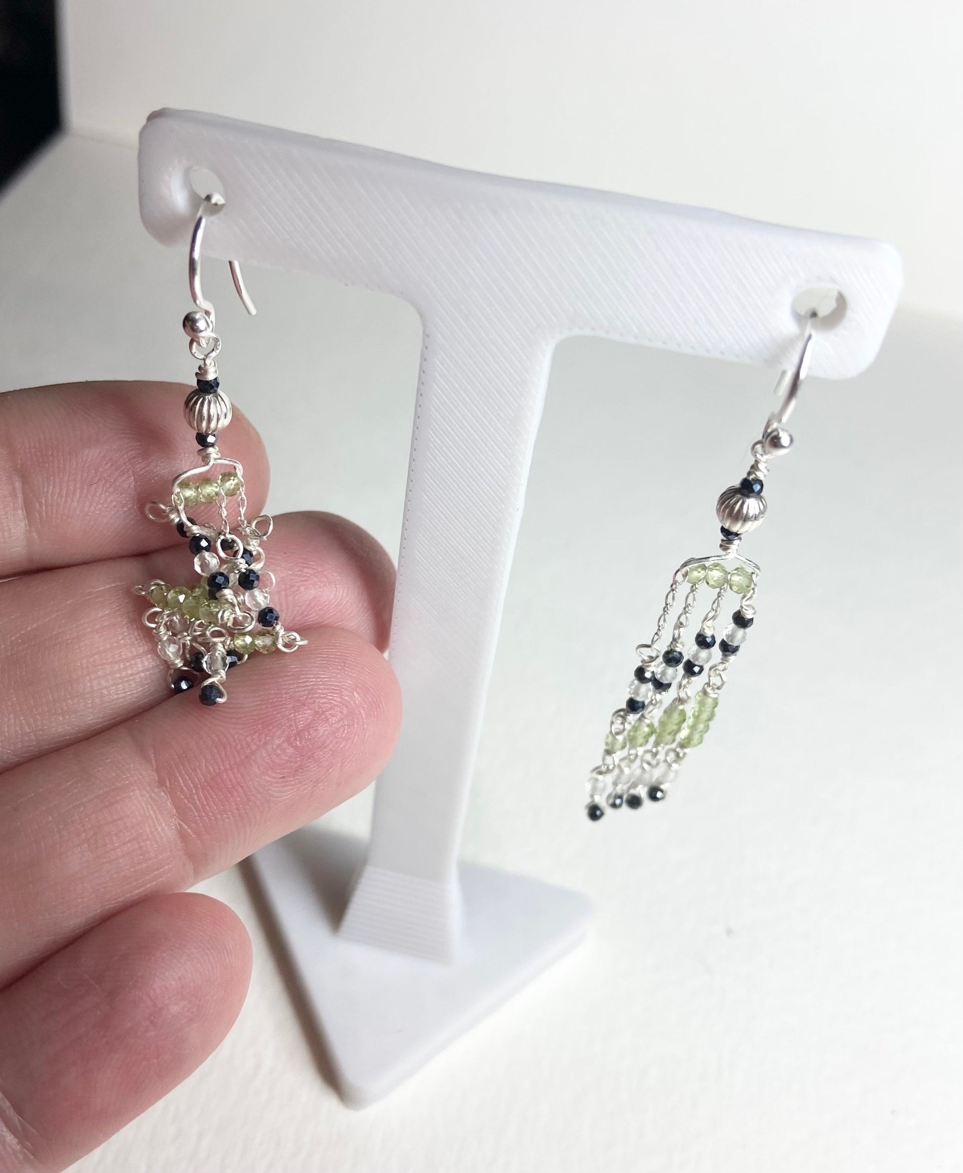 Sterling silver dangle earrings with black diamond and peridot beads.