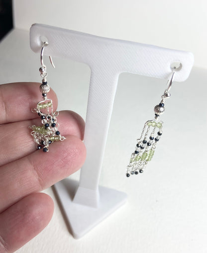 Sterling silver dangle earrings with black diamond and peridot beads.