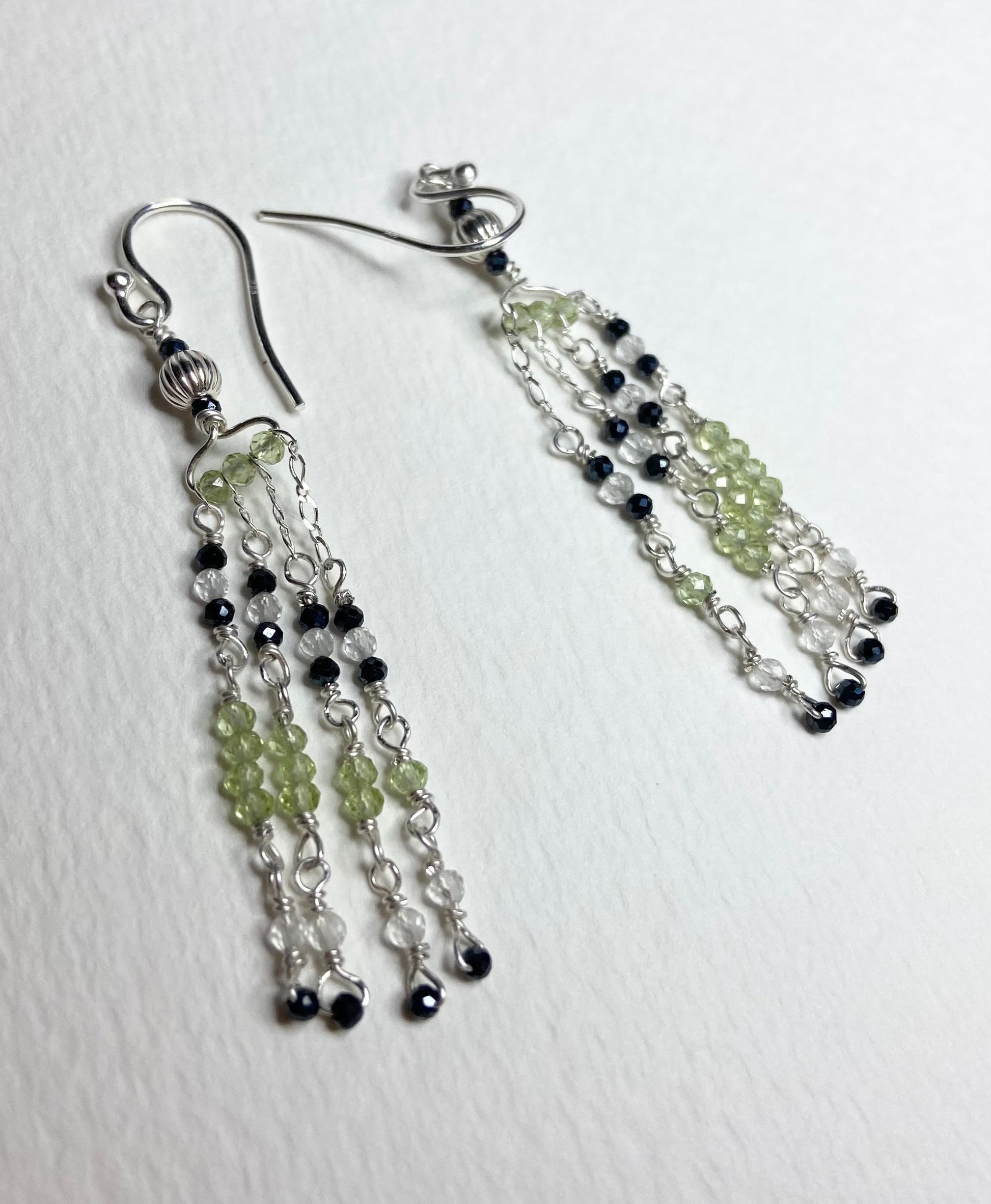 Sterling silver dangle earrings with black diamond, peridot, and quartz beads.