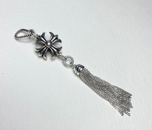 Sterling silver cross tassel pendant with a detailed floral cross and a chain tassel.