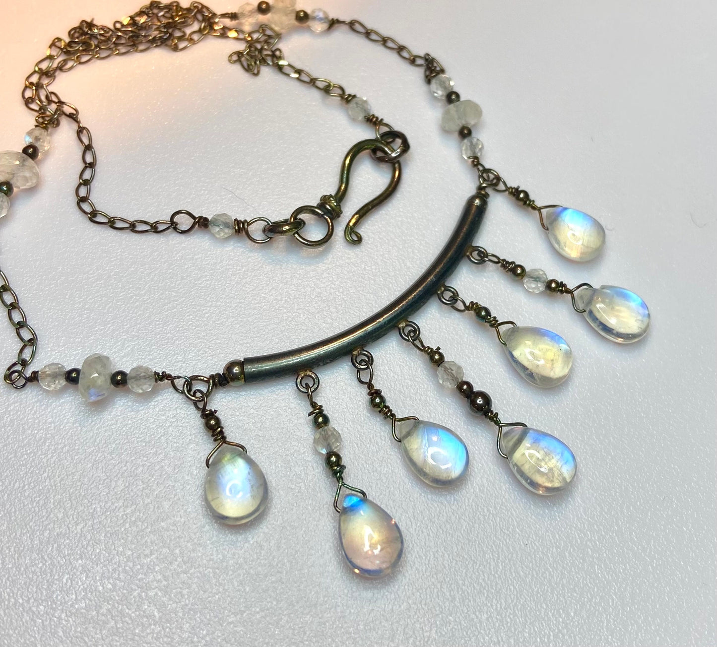 Rainbow blue sheen moonstone sterling silver wire wrapped necklace with tear drop beads.