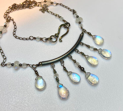 Rainbow blue sheen moonstone sterling silver wire wrapped necklace with tear drop beads.