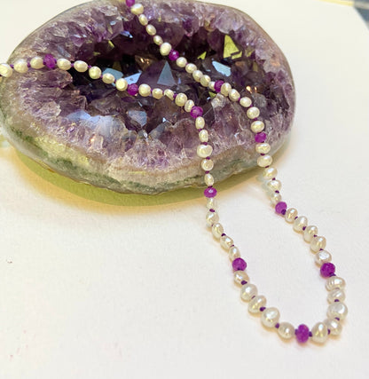 Freshwater oval keshi pearls with purple jade accents on a silk cord.