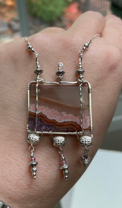 Sterling silver necklace with a rectangular agate and amethyst pendant and pink spinel accents.