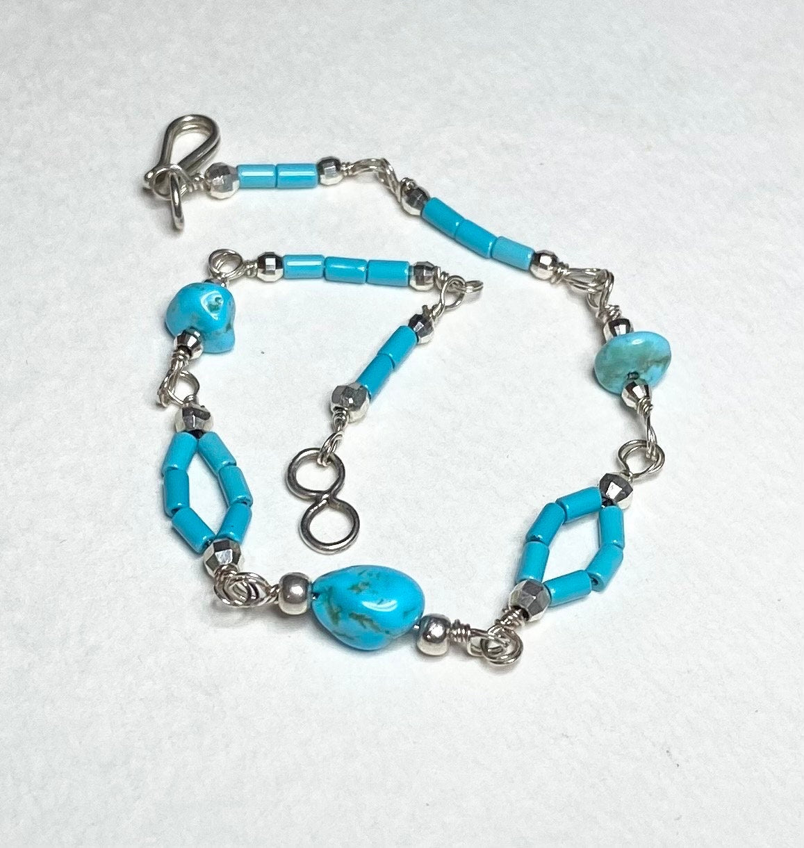 Sterling silver bracelet with turquoise nuggets and beads.