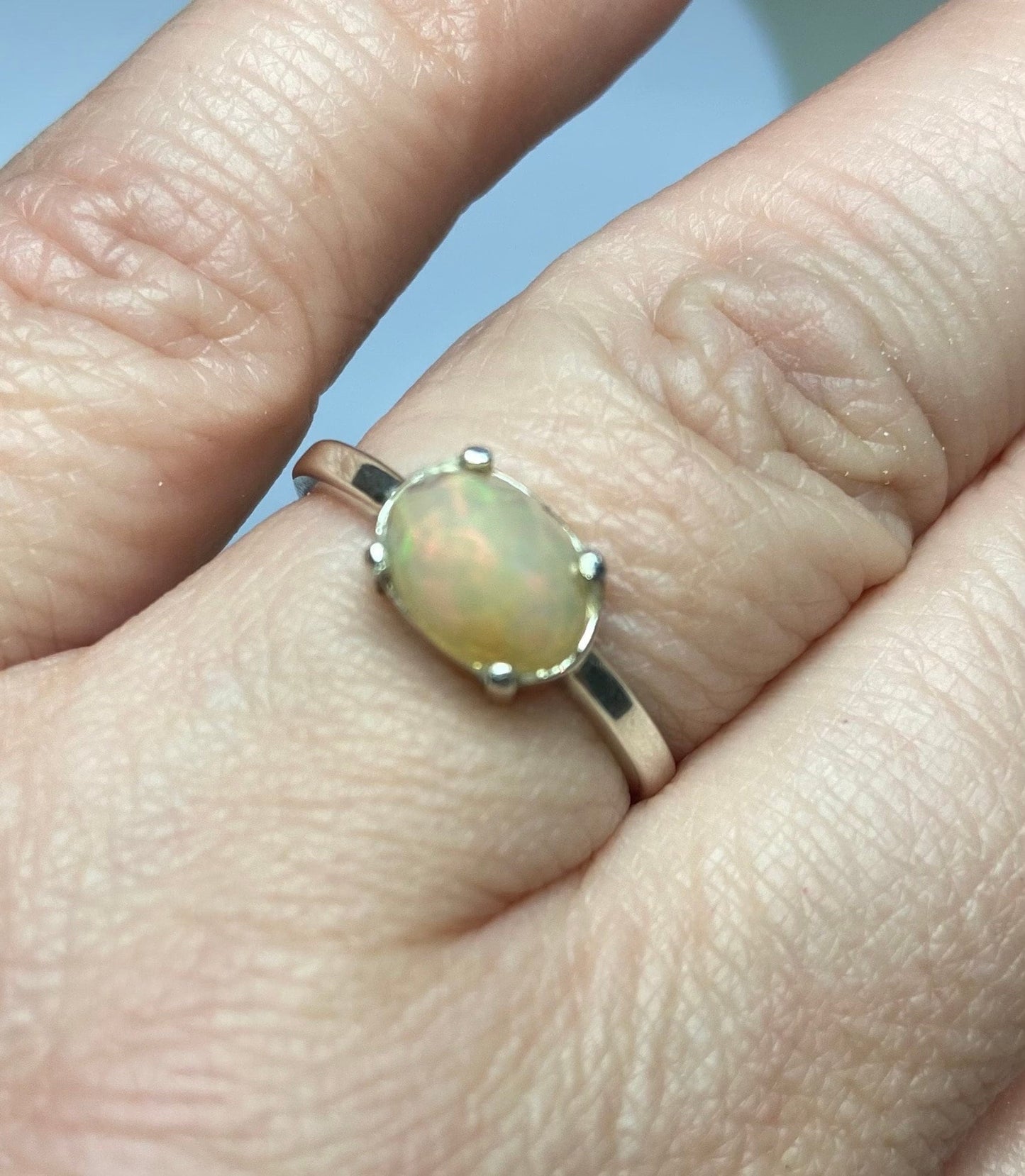 Sterling silver band ring with an oval rose cut Ethiopian Wello opal.