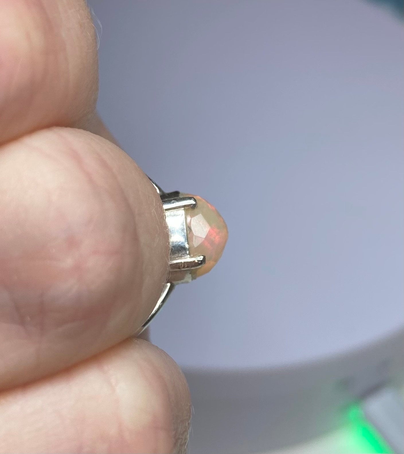 Sterling silver band ring with a faceted rose cut Ethiopian Wello opal.