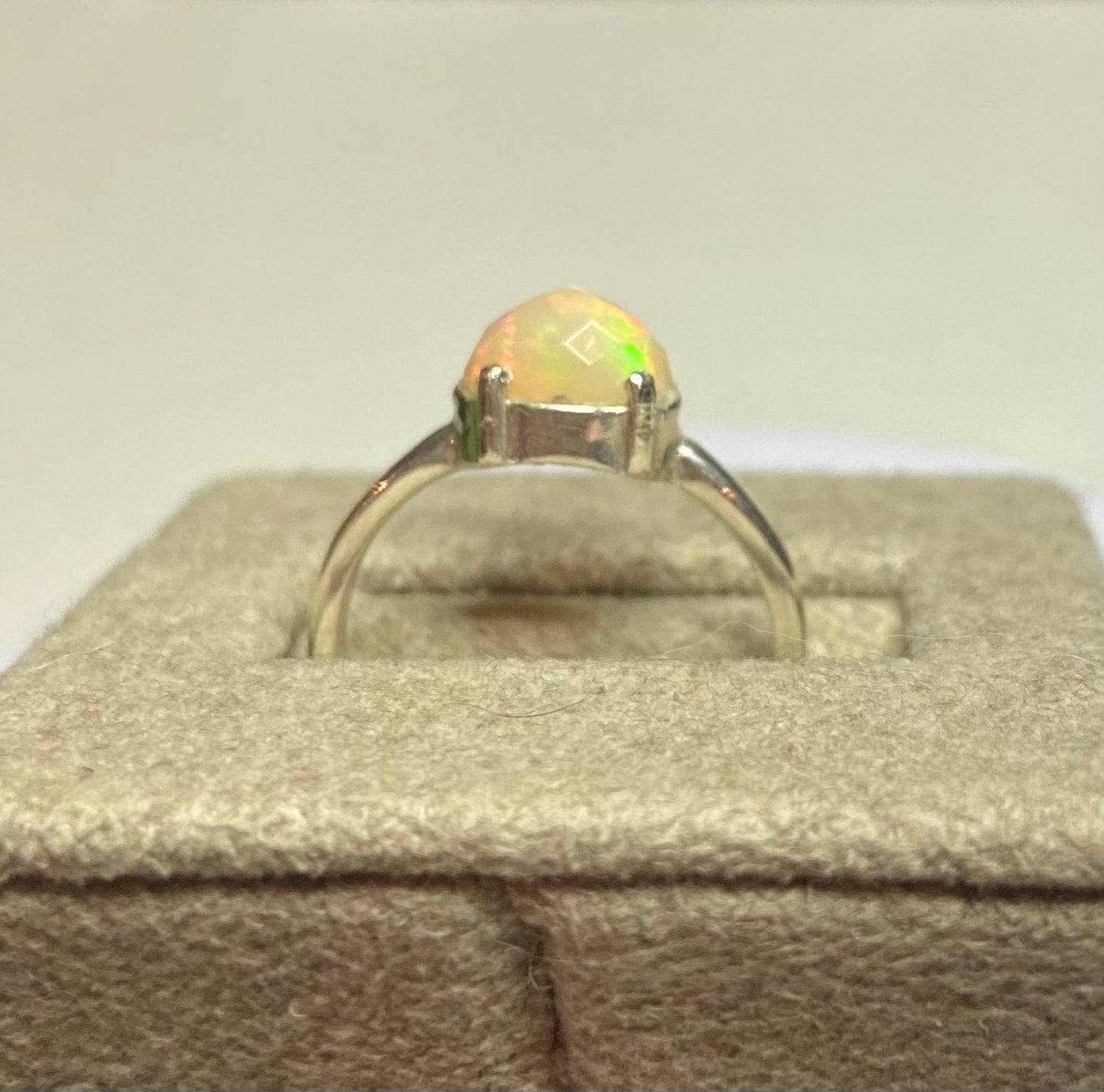 Sterling silver ring with a faceted oval Ethiopian Wello opal.